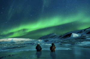 Backpackers watching the Northern Lights